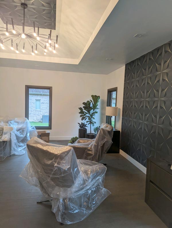 Stylish master bedroom remodeling project with a recessed ceiling with a high-end chandelier.