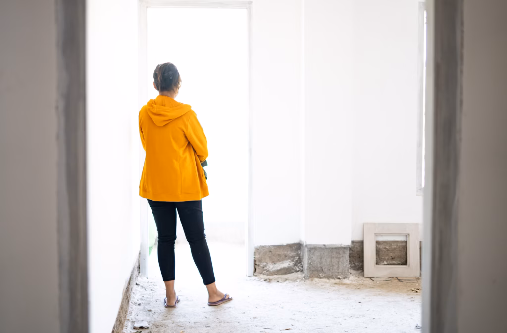 woman looking at unfinished wall in commercial build in Springfield, MO